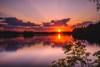 Scenic view of lake against romantic sky during sunset