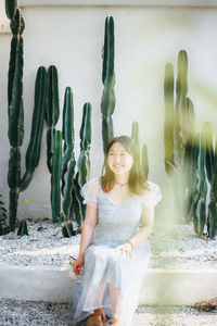 Portrait of young woman standing at beach