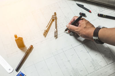 High angle view of man working on paper