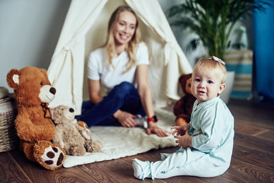 Mom and 1-year-old daughter spend time together at home.