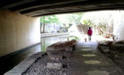 Woman walking in tunnel