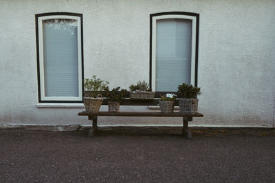 Empty bench against building