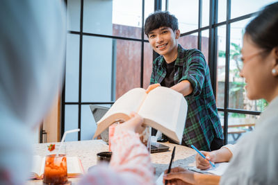 Portrait of young woman working at table