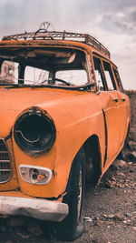 Close-up of old car parked on street in city