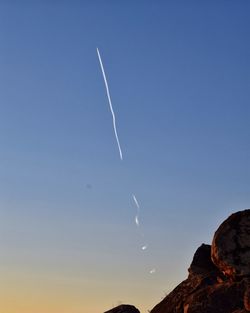 Vapor trails against sky