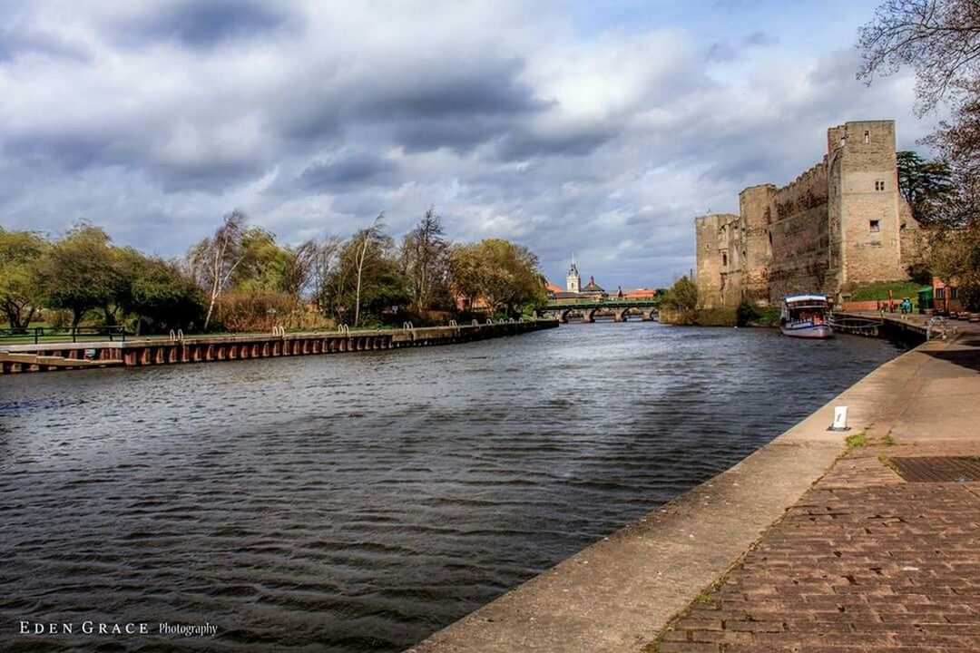 architecture, built structure, water, sky, tree, building exterior, cloud - sky, river, bridge - man made structure, cloud, waterfront, connection, cloudy, canal, transportation, nature, incidental people, day, bridge, rippled