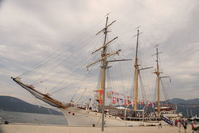 Sailboats moored in sea against sky