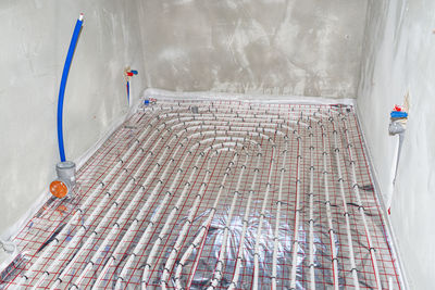 White pipes of underfloor heating systems, distributed in an individual family house on foil.