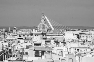 Buildings in city against clear sky