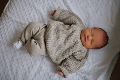 Portrait of cute newborn baby lying on blanket