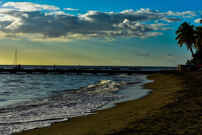 Scenic view of beach against sky during sunset