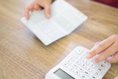 High angle view of person using smart phone on table