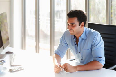 Young man sitting on table