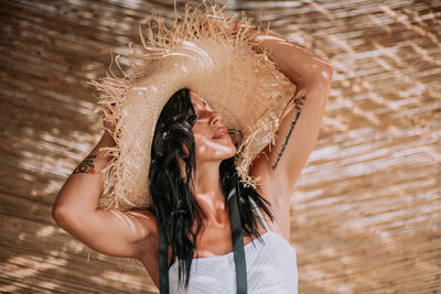 Midsection of woman with arms raised