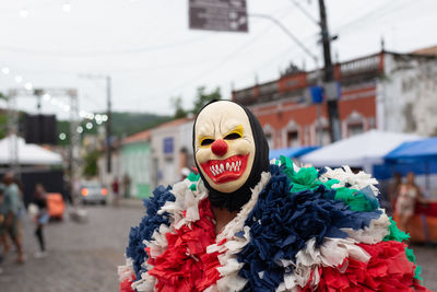 People wearing horror masks are seen playing during the carnival 