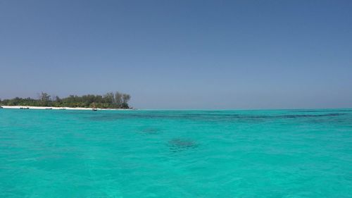 Scenic view of sea against clear blue sky