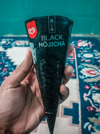 Close-up of hand holding text