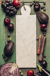 High angle view of vegetables and fruits with cutting board on table