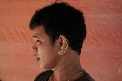Side view of man wearing earrings