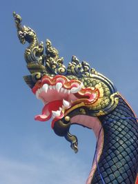 Low angle view of statue against blue sky