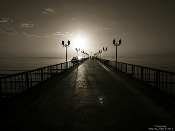 Pier on sea at sunset