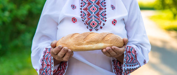 Midsection of woman holding bread