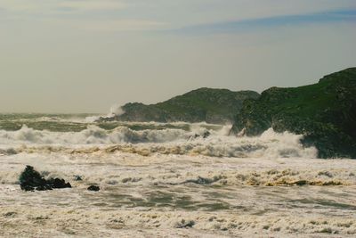 Surf against rock and sky