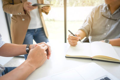 Midsection of business colleagues working in office