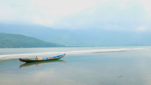 Boat in sea against sky