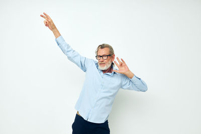 Smiling senior man against white background