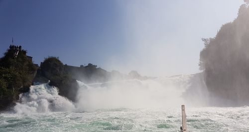 Scenic view of waterfall against sky