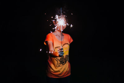 Man wearing mask against black background