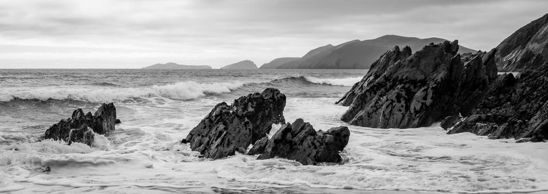 Panoramic view of sea and mountains against sky