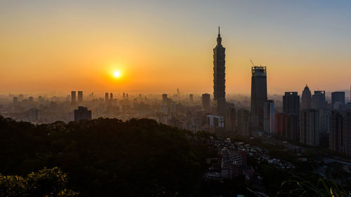 View of buildings in city during sunset