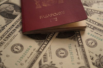 High angle view of passport and currency 