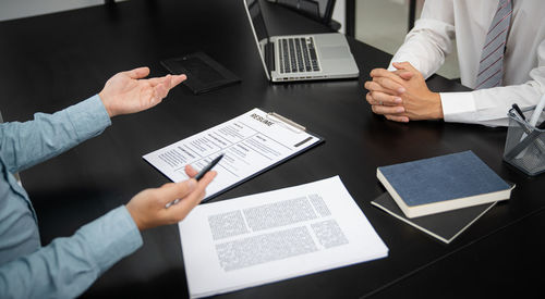 Midsection of business colleagues shaking hands