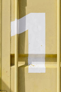 Close-up of railing on staircase against wall