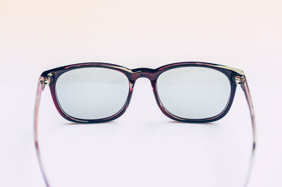 Close-up of sunglasses on table against white background