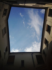 Low angle view of building against cloudy sky