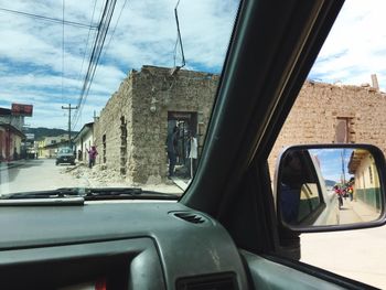 Reflection of cars on side-view mirror of car