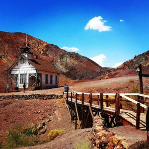 Old house and mountains against blue sky