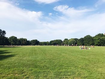 People on field against sky