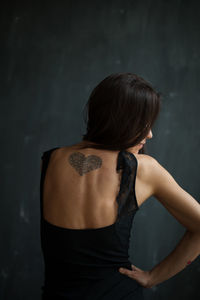 Rear view of woman with tattoo