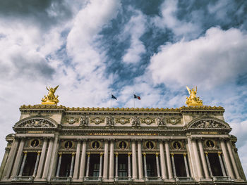 Low angle view of paris' opera against cloudy sky