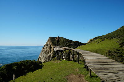 Scenic view of sea against clear blue sky