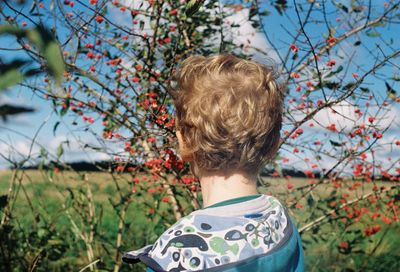 Rear view of boy against plants