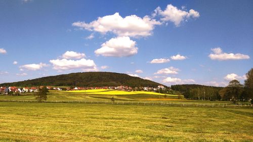 Scenic view of golf course against sky