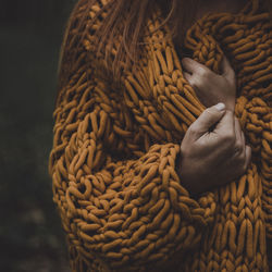 Woman in a chunky cardigan in autumn