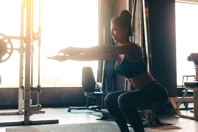 Young woman exercising in gym