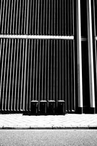 Metallic structure on footpath against building in city
